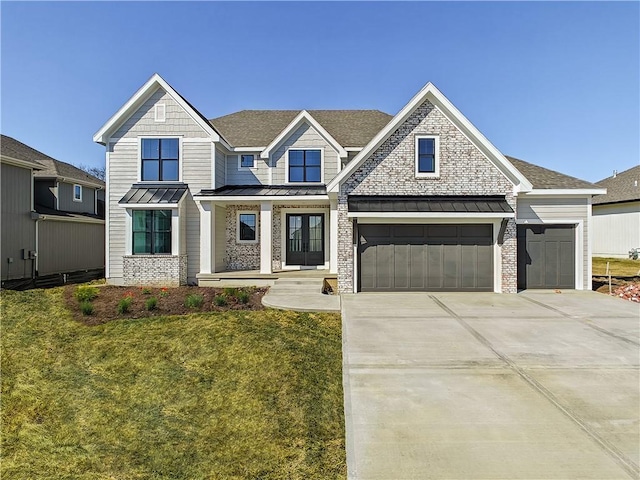 17212 Nieman Rd, Overland Park, KS 66221 - view of front of house featuring a standing seam roof, a front yard, concrete driveway, french doors, and roof with shingles