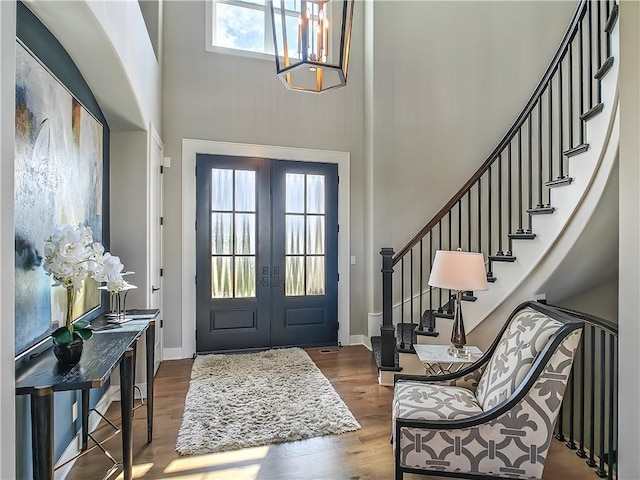 17212 Nieman Rd, Overland Park, KS 66221 - foyer with a towering ceiling, french doors, stairs, dark wood-type flooring, and a chandelier