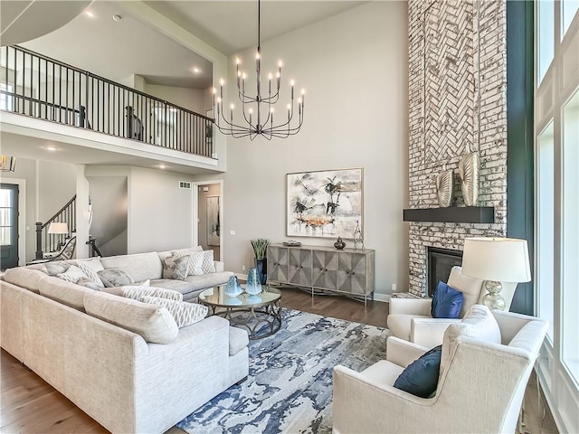 17212 Nieman Rd, Overland Park, KS 66221 - living area with a high ceiling, a chandelier, wood finished floors, stairs, and recessed lighting