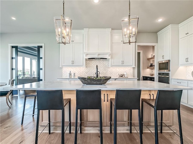 17212 Nieman Rd, Overland Park, KS 66221 - kitchen with stainless steel appliances, a chandelier, white cabinetry, decorative backsplash, and recessed lighting