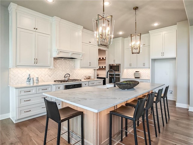 17212 Nieman Rd, Overland Park, KS 66221 - kitchen featuring a chandelier, a sink, white cabinets, decorative backsplash, and baseboards