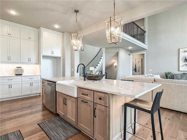 17212 Nieman Rd, Overland Park, KS 66221 - kitchen with a sink, stainless steel dishwasher, a chandelier, open floor plan, and light wood-type flooring