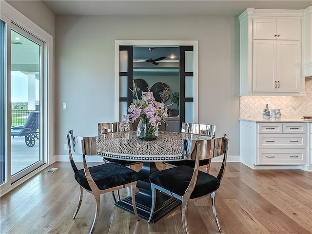 17212 Nieman Rd, Overland Park, KS 66221 - dining room with light wood-style floors, a ceiling fan, and baseboards