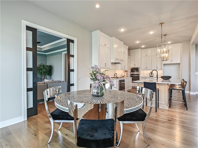 17212 Nieman Rd, Overland Park, KS 66221 - dining room featuring recessed lighting, light wood-style floors, a chandelier, and baseboards