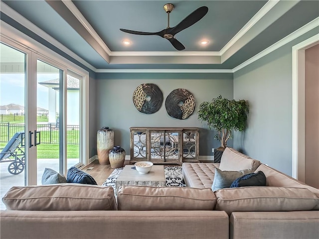 17212 Nieman Rd, Overland Park, KS 66221 - living area with a ceiling fan, a tray ceiling, ornamental molding, wood finished floors, and baseboards