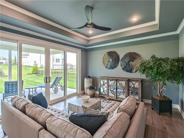 17212 Nieman Rd, Overland Park, KS 66221 - living room featuring ornamental molding, a raised ceiling, a ceiling fan, baseboards, and wood finished floors