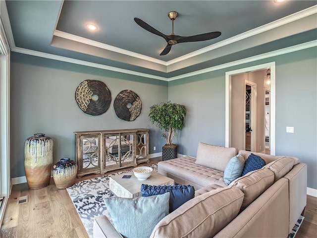 17212 Nieman Rd, Overland Park, KS 66221 - living area with ceiling fan, wood finished floors, a raised ceiling, crown molding, and baseboards