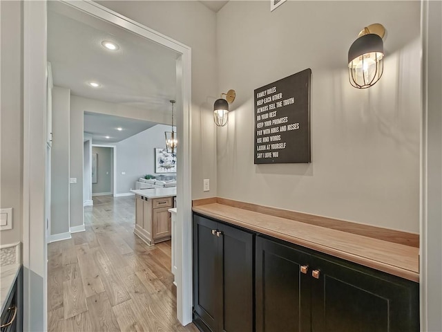 17212 Nieman Rd, Overland Park, KS 66221 - hallway with light wood-style floors, a chandelier, recessed lighting, and baseboards
