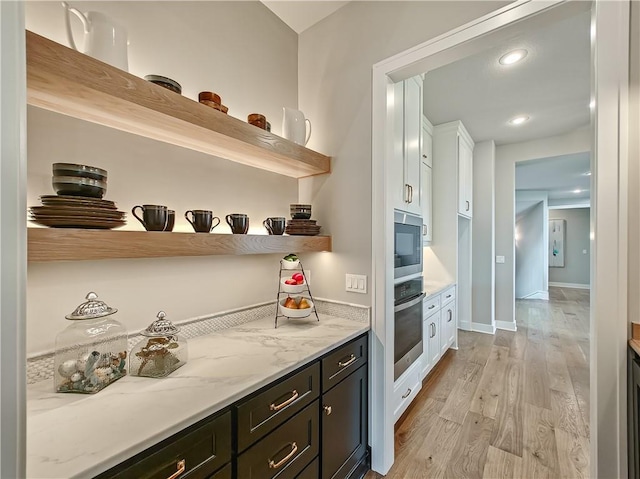 17212 Nieman Rd, Overland Park, KS 66221 - bar featuring stainless steel appliances, light wood-style flooring, baseboards, and recessed lighting