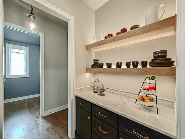 17212 Nieman Rd, Overland Park, KS 66221 - bar featuring dark wood-style floors and baseboards