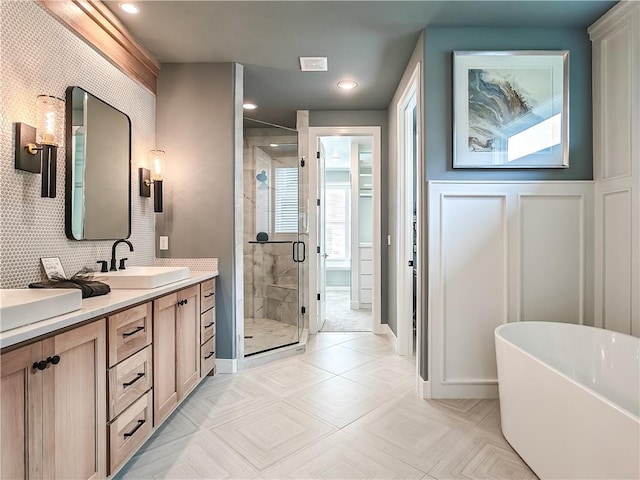 17212 Nieman Rd, Overland Park, KS 66221 - bathroom featuring vanity, a shower stall, a freestanding bath, recessed lighting, and baseboards