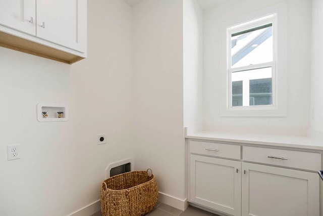 laundry room featuring cabinets, light tile patterned flooring, electric dryer hookup, and washer hookup