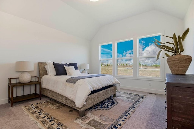 bedroom with carpet floors and vaulted ceiling