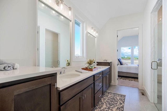 bathroom featuring lofted ceiling, vanity, tile patterned flooring, and an enclosed shower