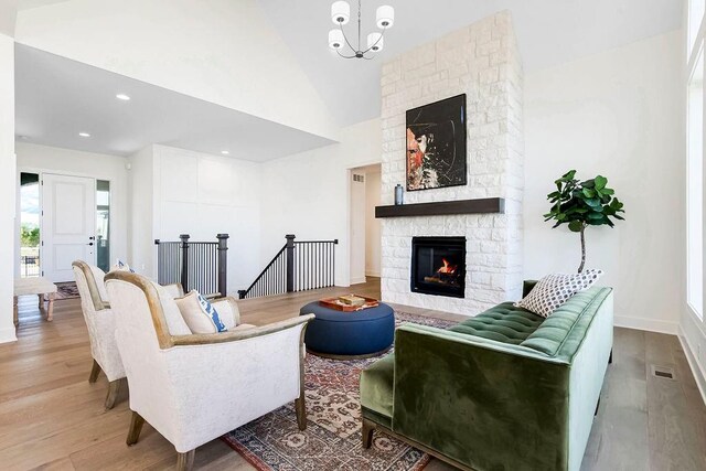 4209 W 158th St, Overland Park, KS 66224 - living area with high vaulted ceiling, visible vents, baseboards, a fireplace, and wood finished floors