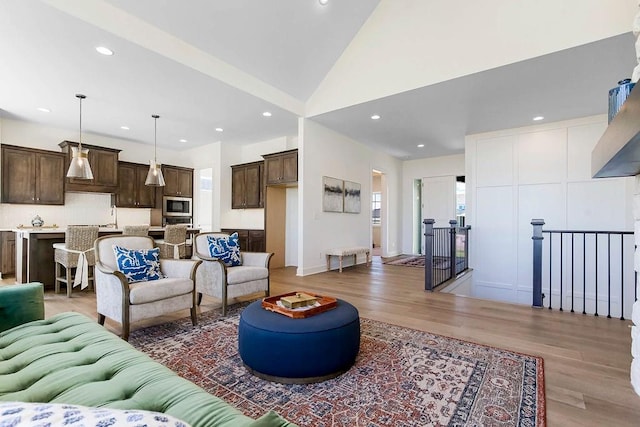 living room with vaulted ceiling and hardwood / wood-style floors