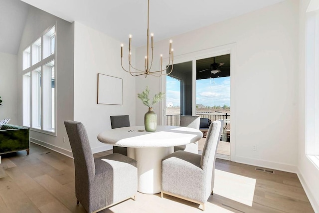 dining room with an inviting chandelier and light hardwood / wood-style floors