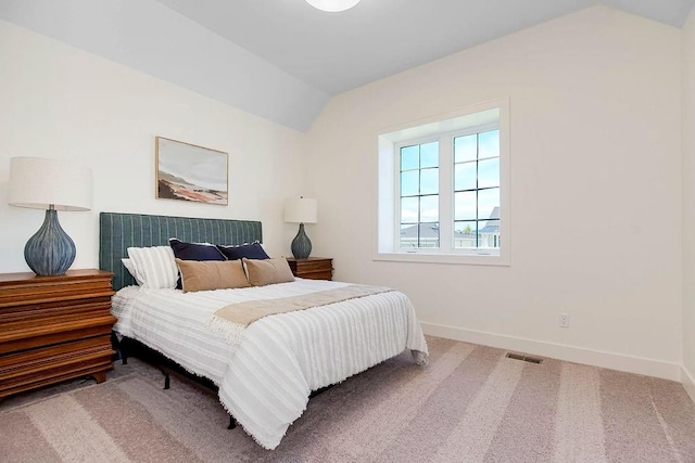 bedroom with vaulted ceiling and carpet flooring