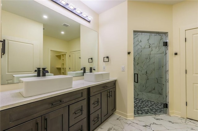 bathroom with vanity and a shower with shower door