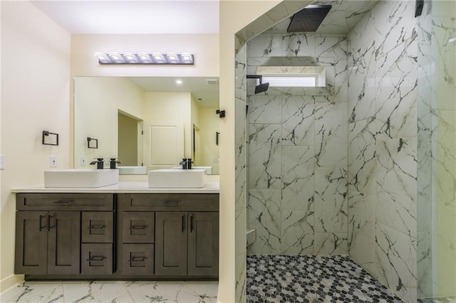 bathroom with vanity and a tile shower