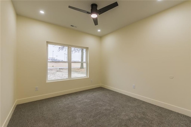 unfurnished room with ceiling fan and dark colored carpet