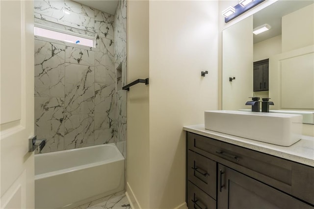 bathroom featuring tiled shower / bath and vanity