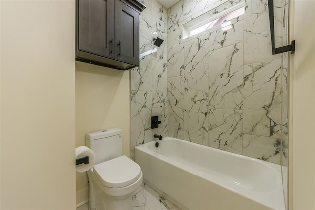 bathroom with tiled shower / bath combo and toilet