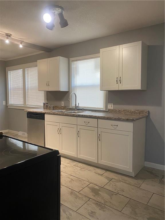 kitchen with light tile patterned flooring, white cabinets, dishwasher, and rail lighting