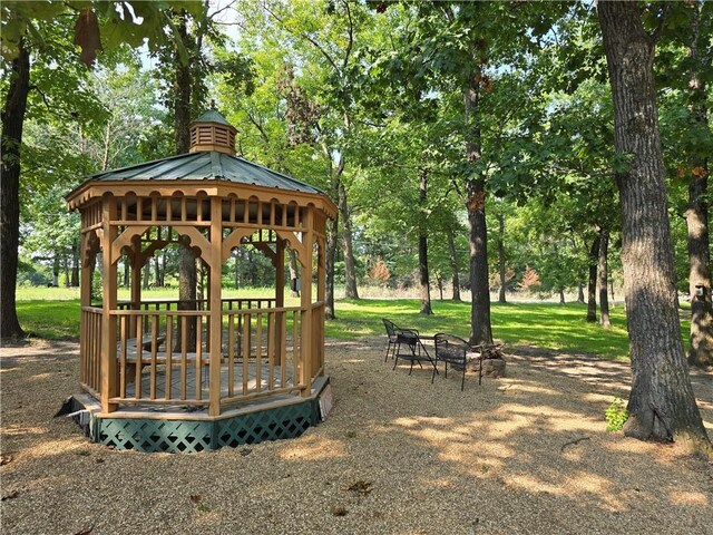 surrounding community featuring a gazebo and an outdoor fire pit