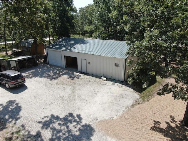 exterior space featuring a garage and an outdoor structure