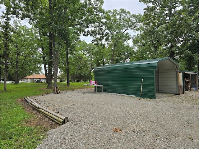 view of outbuilding featuring a lawn