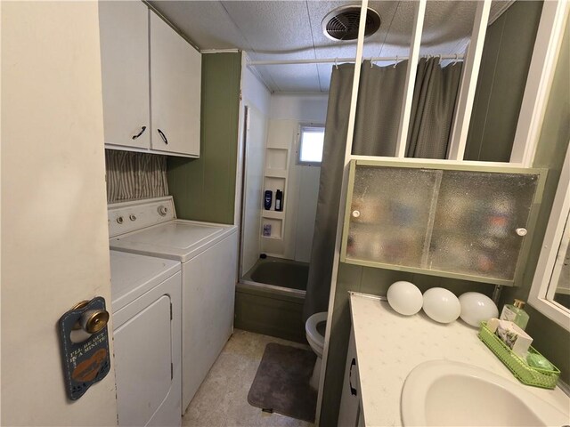 laundry area with washer and clothes dryer, sink, and light tile patterned floors