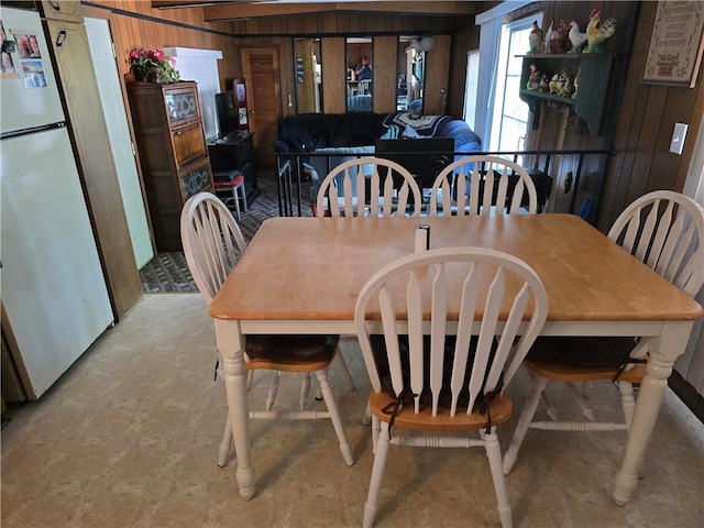 tiled dining area with wooden walls