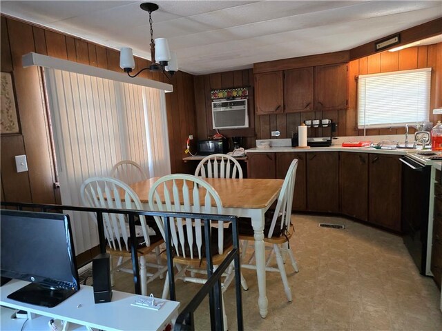 kitchen featuring wood walls, sink, stove, and a chandelier