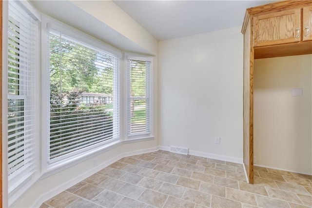 empty room featuring visible vents and baseboards