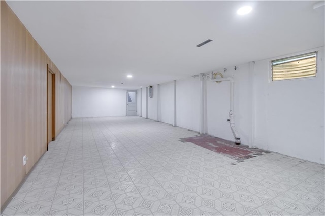 basement with light floors, visible vents, and recessed lighting