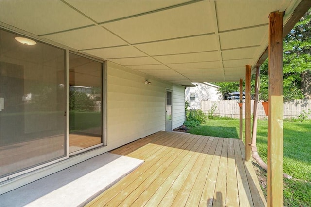 deck featuring fence and a lawn