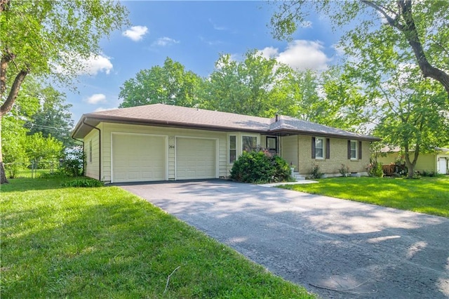 single story home featuring a front lawn, driveway, and an attached garage