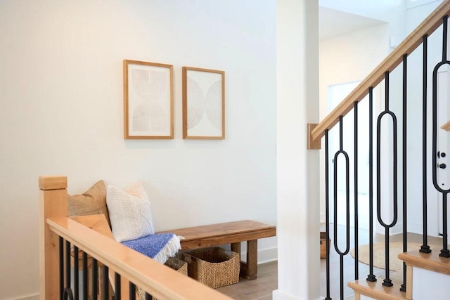 stairway with hardwood / wood-style floors