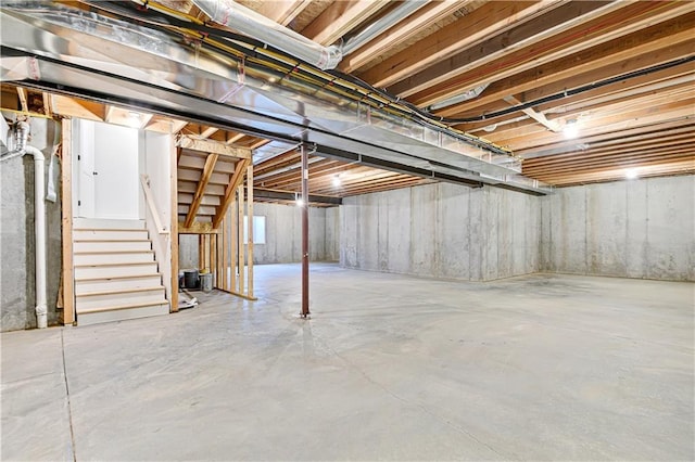 unfinished basement featuring stairs