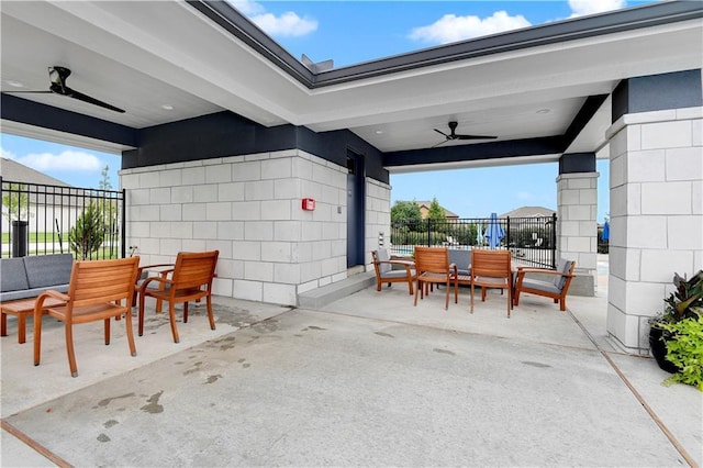 view of patio featuring outdoor dining area and a ceiling fan