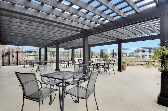 view of patio featuring outdoor dining area, a pergola, and fence