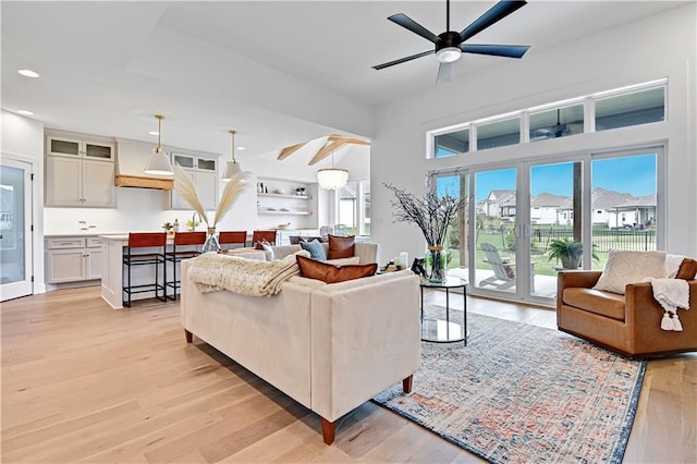 living area featuring recessed lighting, light wood-type flooring, and ceiling fan