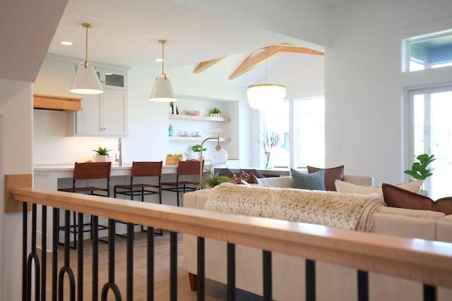 living room with recessed lighting, wood finished floors, and built in shelves