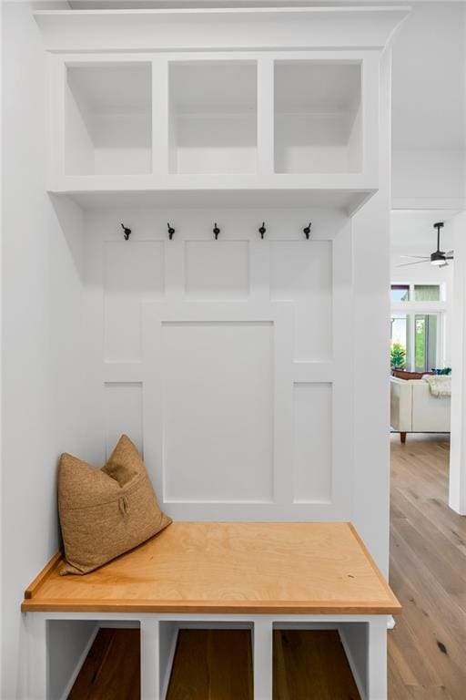 mudroom with light wood finished floors and ceiling fan