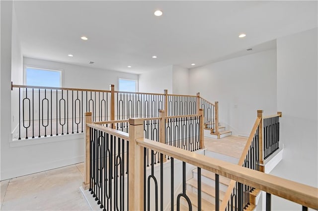 hallway featuring recessed lighting, baseboards, and a healthy amount of sunlight