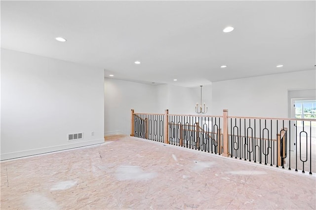 unfurnished room with recessed lighting, visible vents, baseboards, and an inviting chandelier