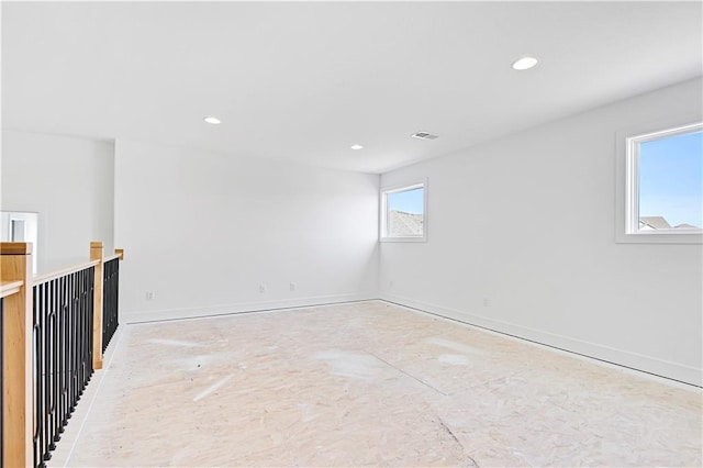 unfurnished room with recessed lighting and baseboards