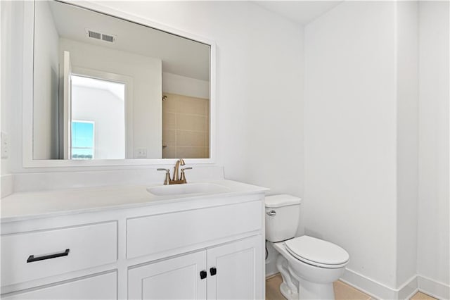 bathroom with visible vents, toilet, vanity, and baseboards