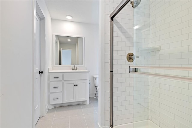 full bathroom with vanity, tile patterned floors, toilet, and a stall shower